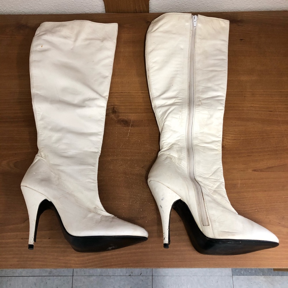 Two Lips knee high white leather boots.
